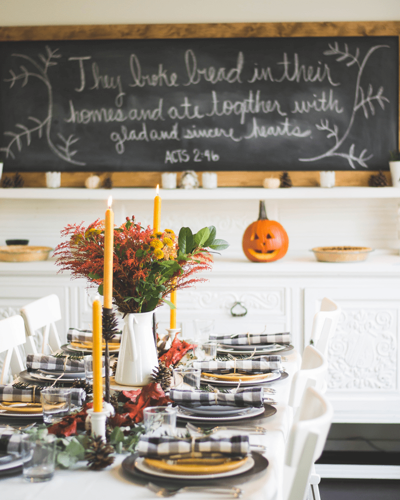 full table setting with candles and white table cloth