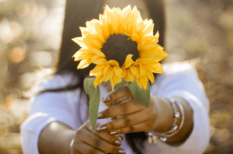 Woman holding sunflower