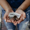 Hands holding change with note that says make a change