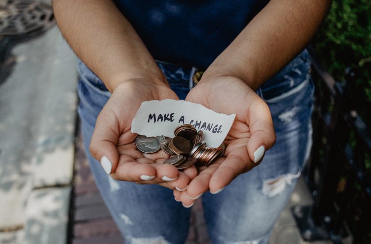 Hands holding change with note that says make a change