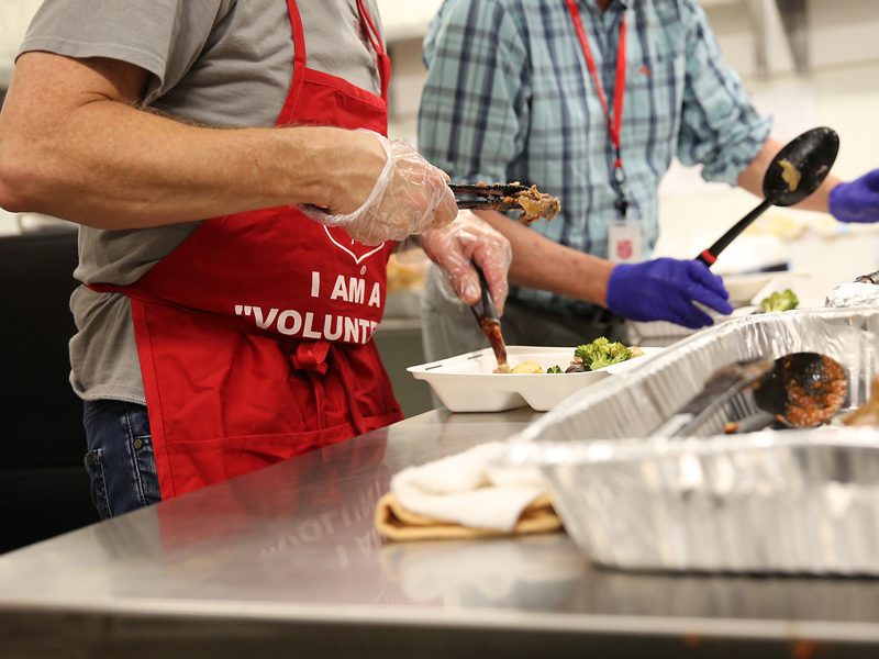 closeup of EDS volunteers preparing meals 