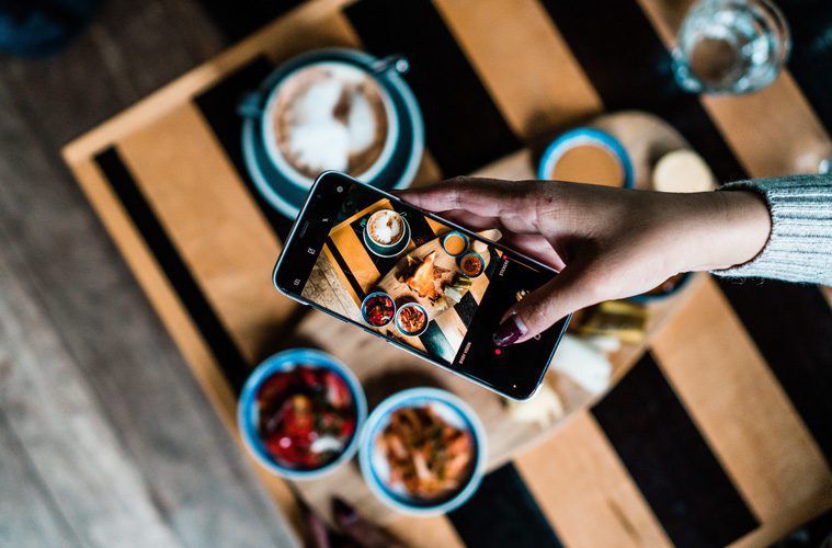 Cellphone being held at table