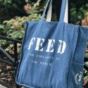 Blue FEED Project Bag in Front of Plants