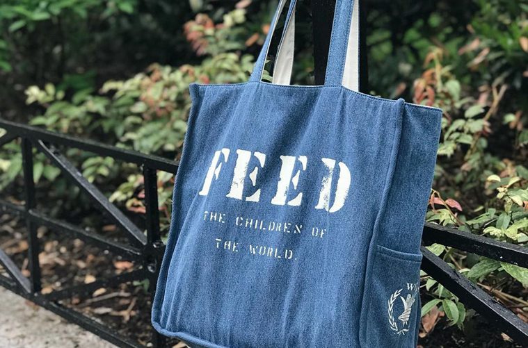 Blue FEED Project Bag in Front of Plants