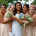 Female Friends Hugging and Smiling Around Bride