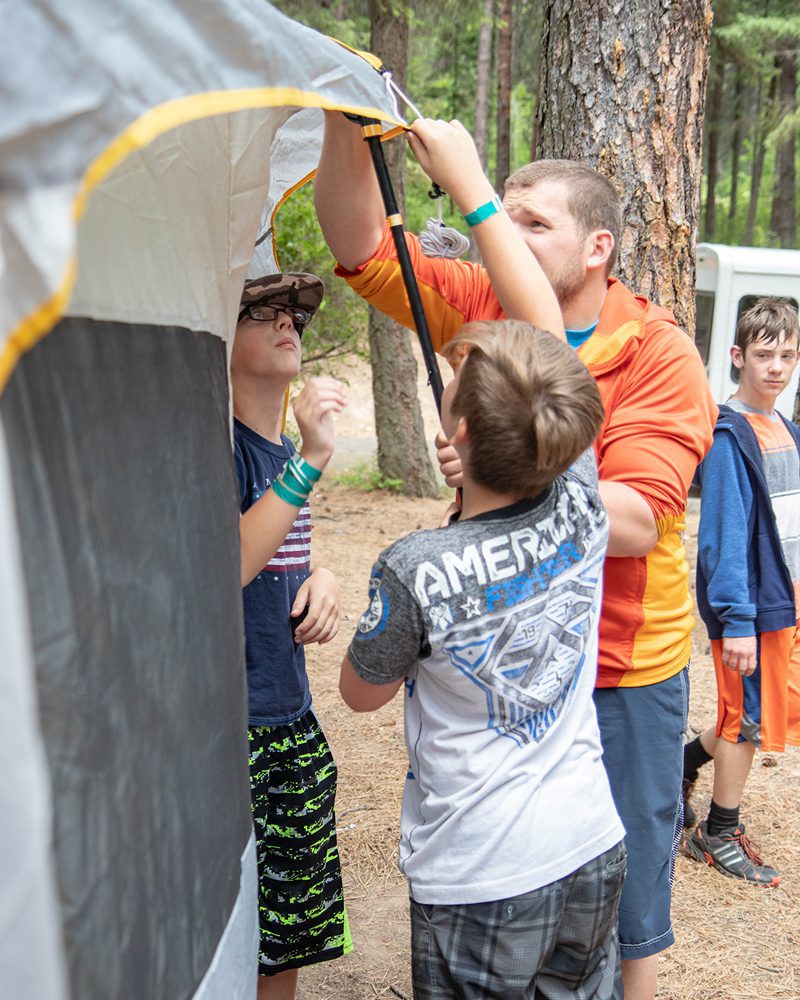 Coeur d'Alene Kroc Center Counselor Helping Set Up Tent with Campers