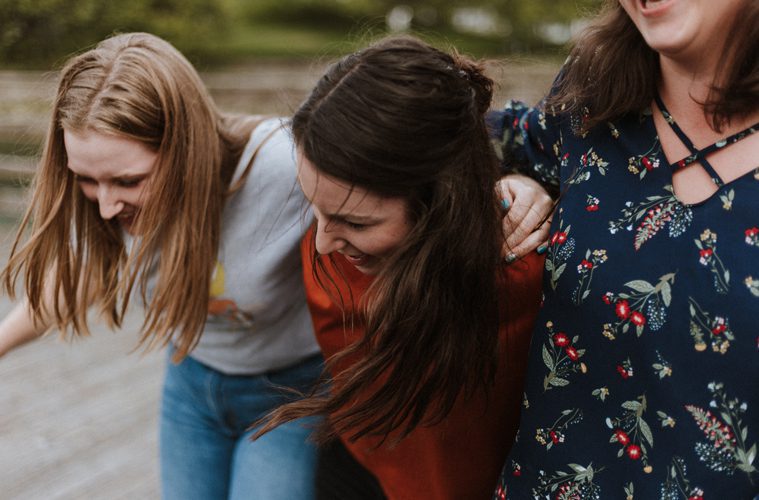 Female Friends Happy with Arms Around Each Other