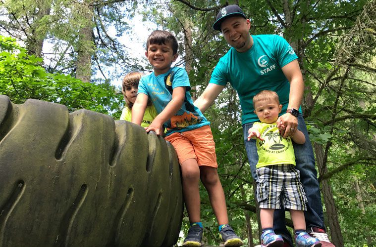 Counselor Joshua Hamilton Playing with Three Kids at Camp