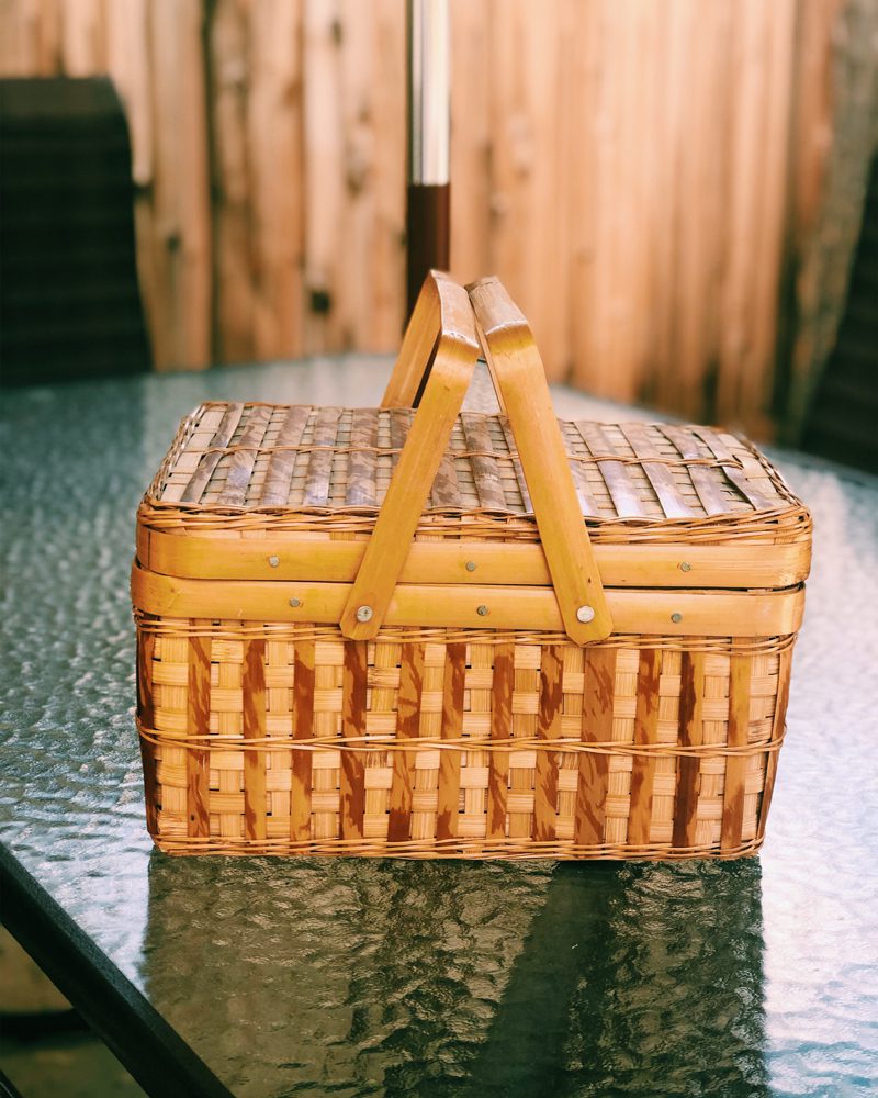 Closed Picnic Basket on Glass Table