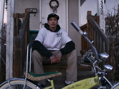 Robert Wallace Sitting on Porch with Custom Built Bike