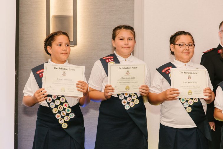 Three Sunbeam Troops with Badges Holding Commissioner's Award 