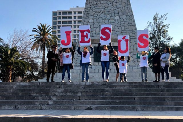 Children holding letters that spell Jesus