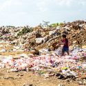 Child Dumping Trash on Beach