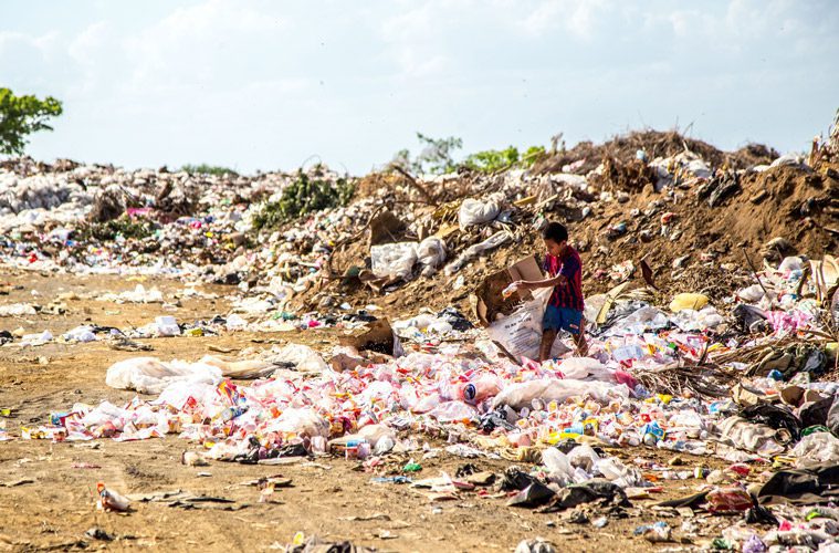 Child Dumping Trash on Beach