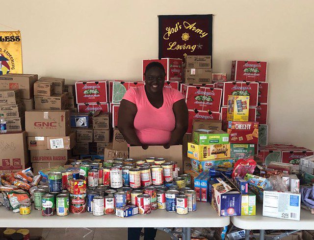 Smiling Emergency Response Team Member Prepares Food for Distribution