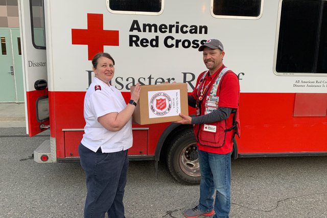 Red Cross and Salvation Army Workers in Front of Red Cross Truck with Box