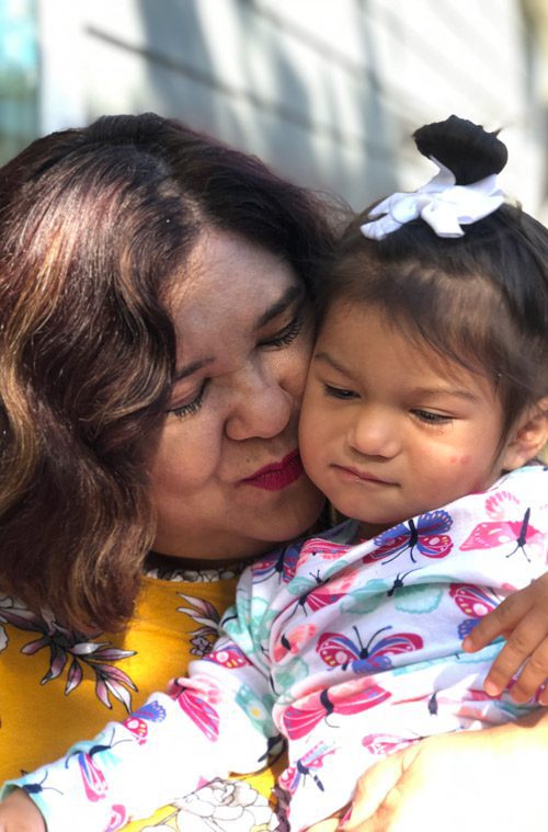 Grandmother holding granddaughter 