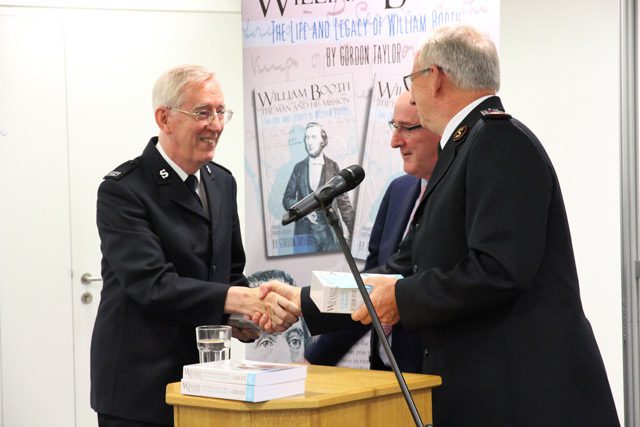 Gordon Taylor Shaking Hands During Presentation of his Book