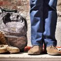Veteran with army boots next to him in civilian clothes