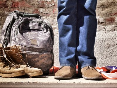 Veteran with army boots next to him in civilian clothes