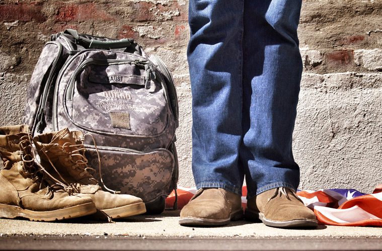 Veteran with army boots next to him in civilian clothes