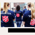 Salvation Army Volunteers with backs turned in volunteer shirts
