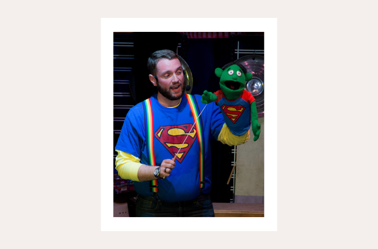 Captain Mark Davey in superman shirt with puppet wearing same shirt