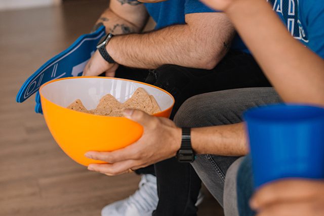 Chip Bowl Being Held By Friends on Couch