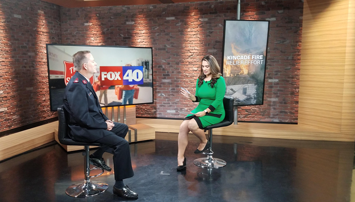 Salvation Army Officer speaking with Fox 40 Anchor