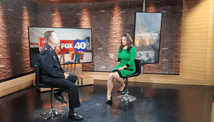 Salvation Army Officer speaking with Fox 40 Anchor