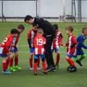 soccer coach talking to youth team
