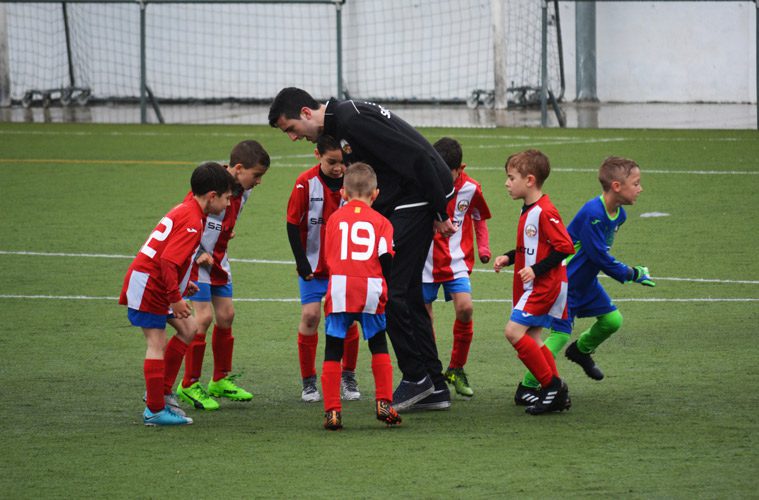 soccer coach talking to youth team