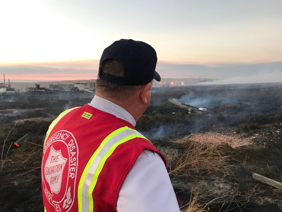 Salvation Army EDS Member Looking at Damage Caused by Fire