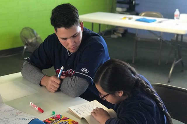 Cleveland Indians Recruit Helping Child with Homework