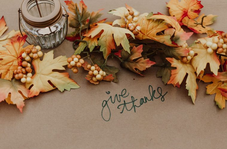 Leaves surrounding the words "give thanks"