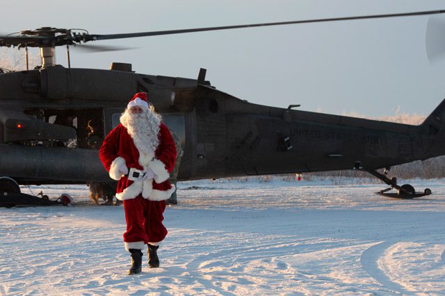 National Guard Member in Santa Outfit exiting Helicopter