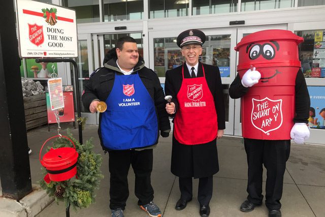 Harrison, Commissioner Hodder, and Kettle Man ringing bells outside