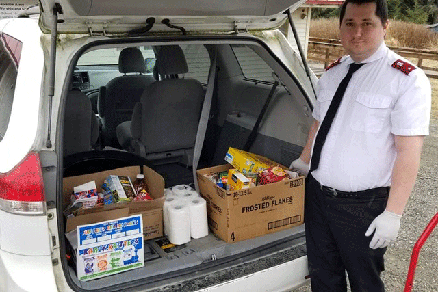 man standing by trunk full of boxes