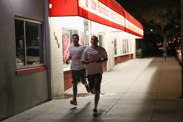 two people running by salvation army store