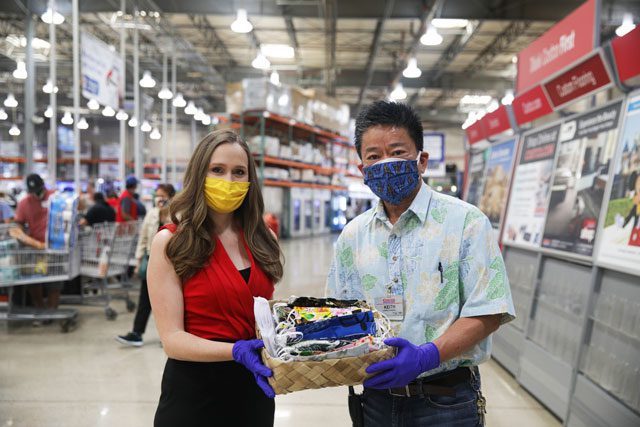 Man and woman holding basket with masks