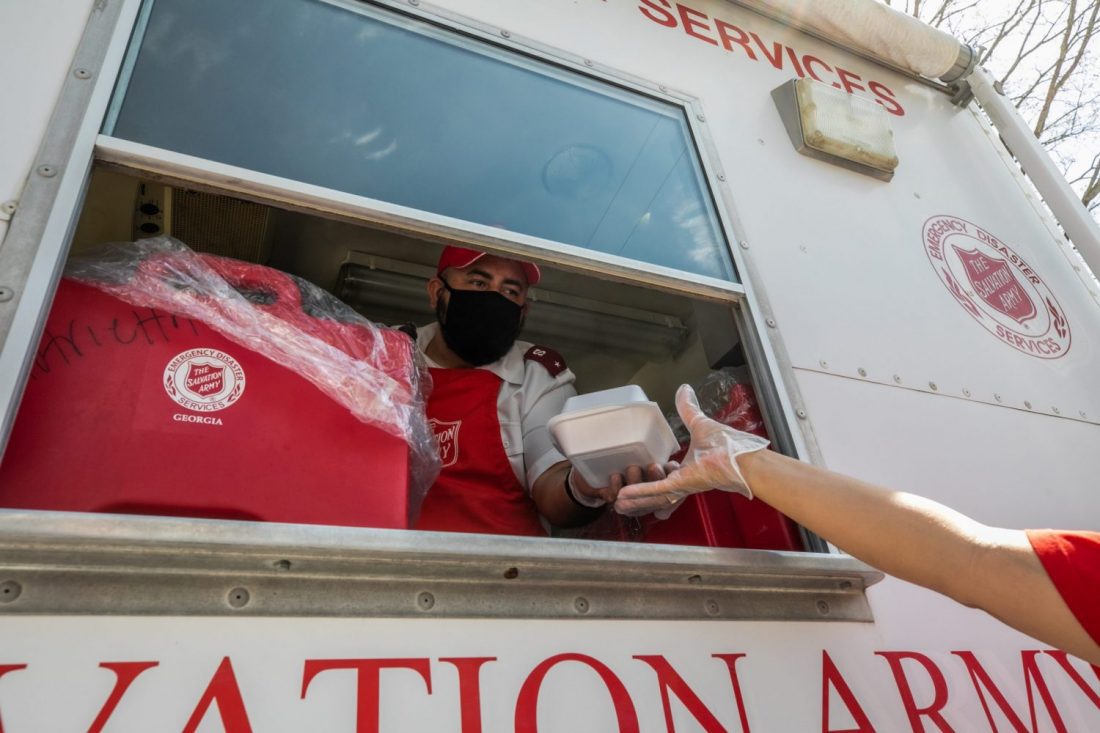 EDS worker distributing food from inside van