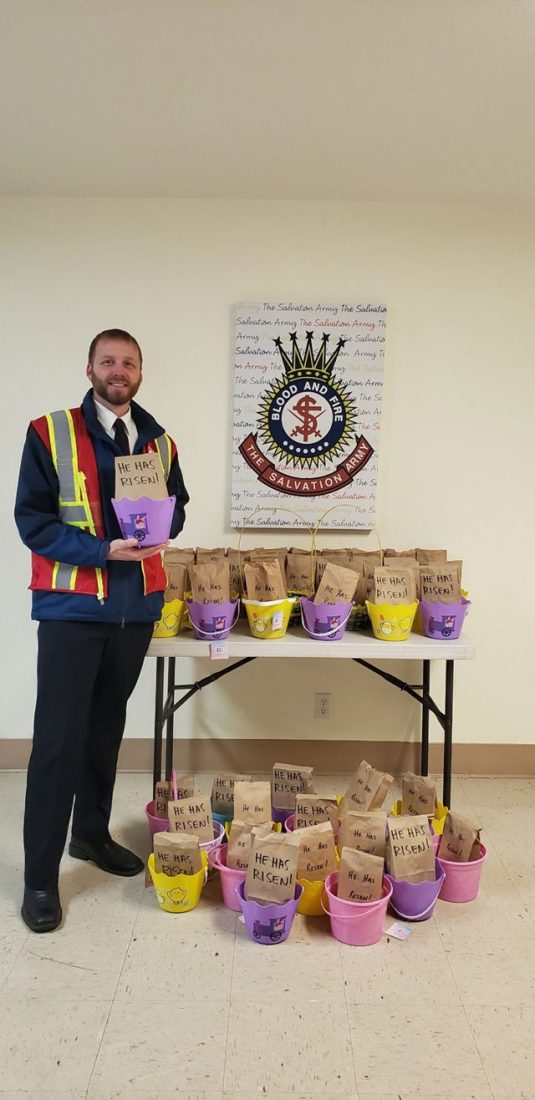 EDS worker in front of Easter bags on table