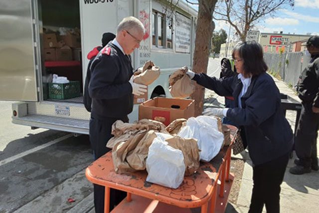 Man and women organizing bags