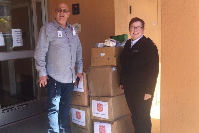 Man and women next to stack of boxes