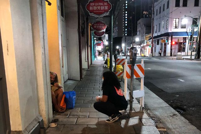 Woman helping homeless person