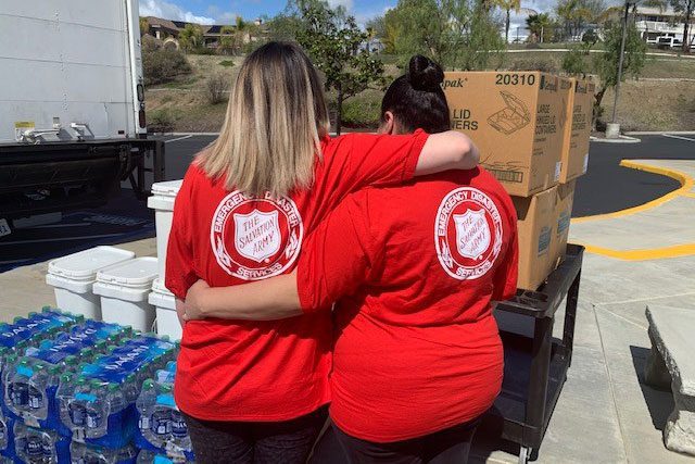 Salvation Army workers with arms around each other