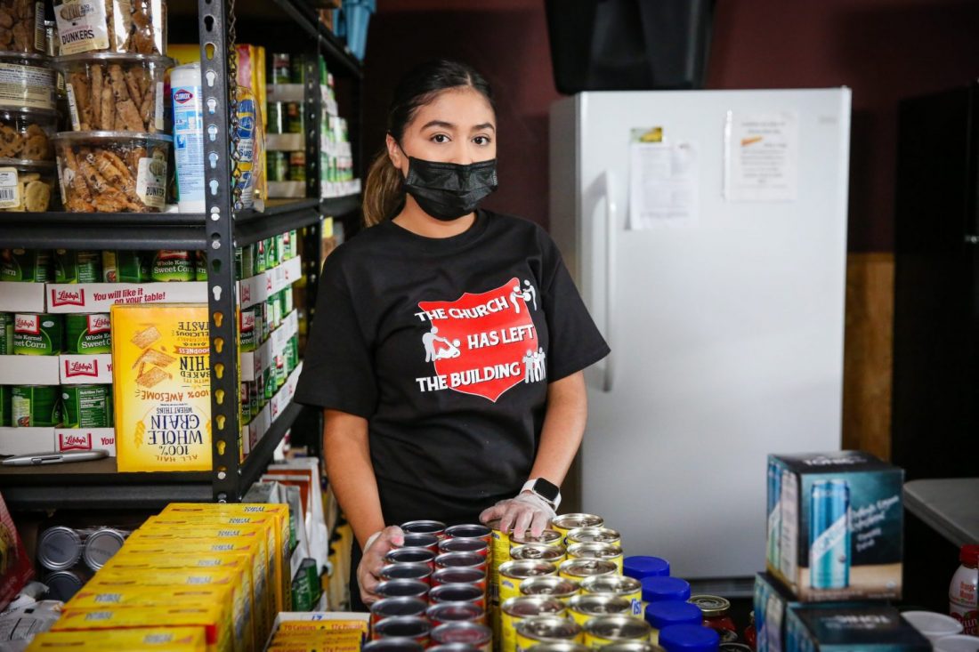 Woman with facemask in food kitchen