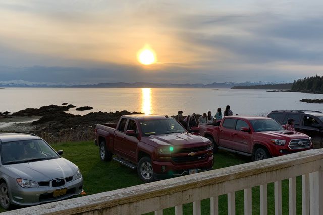 cars parked in front of body of water