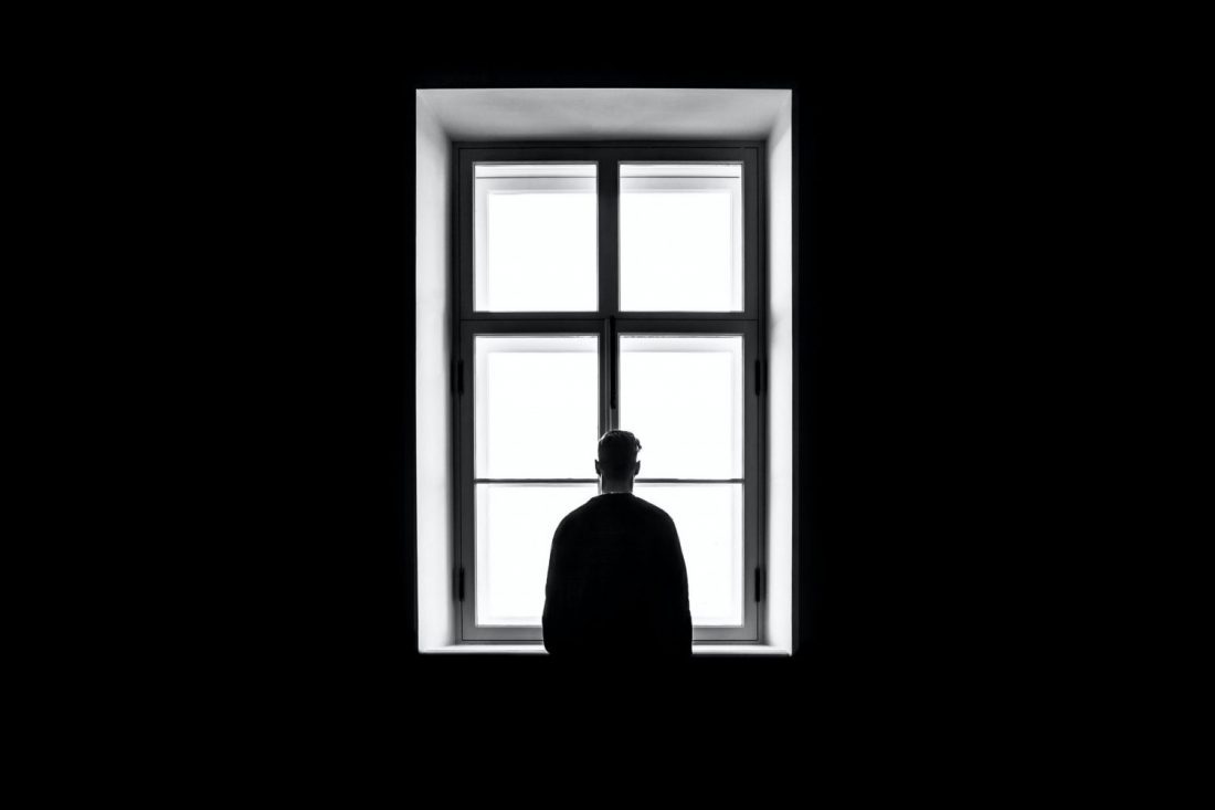 Silhouette of person in front of window