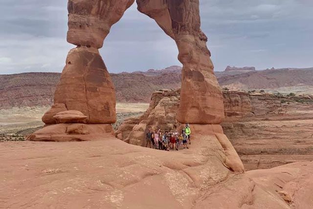 Group under rock arch